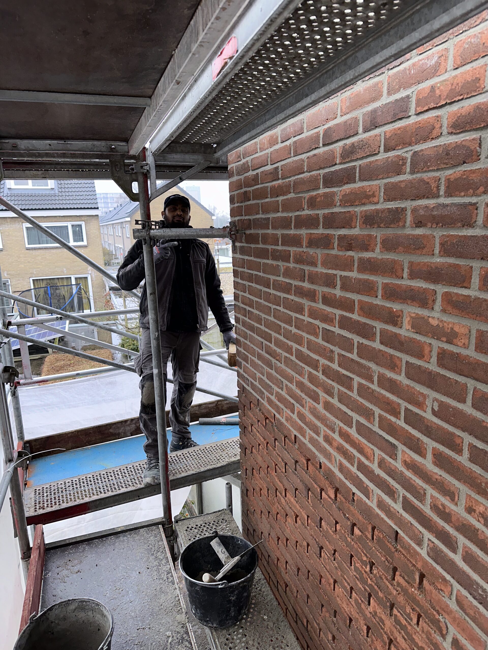 Vakman aan het werk aan een gevel